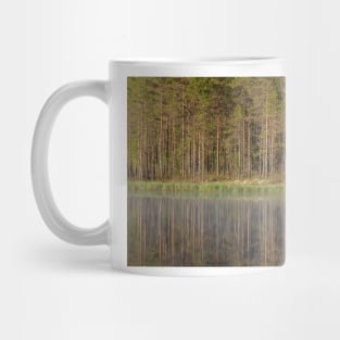 Forest reflecting to small lake at summer morning Mug